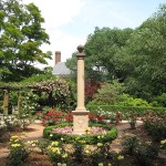 Garden with statuory pillar in center.